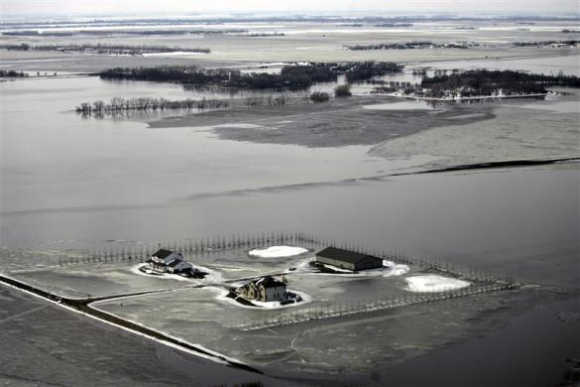 An aerial view shows snow, ice, and water from overland flooding cover the landscape south of Fargo, North Dakota.