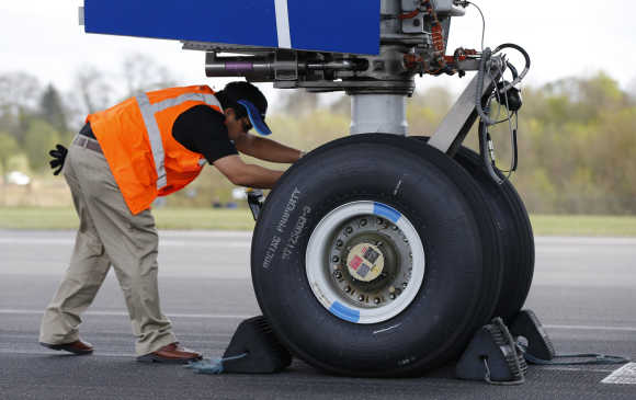 An engineer examines one of the engines of Boeing's new 787 Dreamliner aircraft.