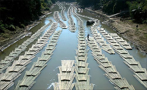 Bamboo logs are transported down the river Longai near Kanmun village, about 235 km (146 miles) west from Aizawl, Mizoram's capital city.
