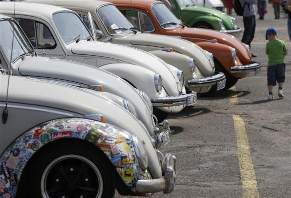 A child passes a row of Beetle cars during the 29th annual May Beetle meeting in Hanover.