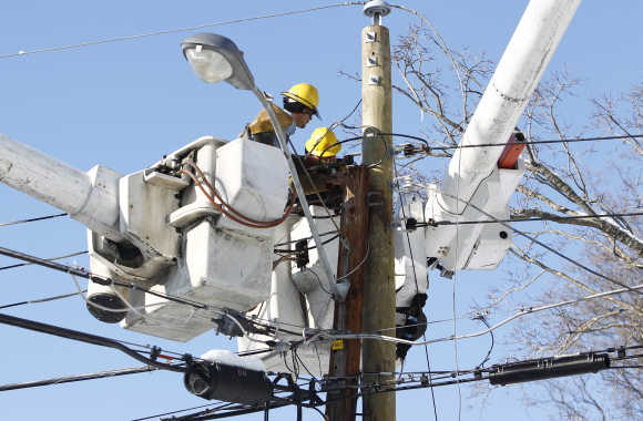 Utility workers attempt to restore power to residents in Falls Church, Virginia, US.