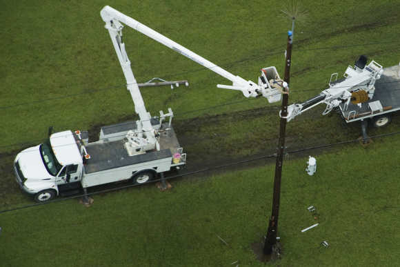 Power crews work on lines in Port Arthur, Texas.