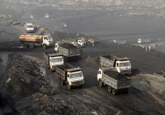 Trucks move in the Mahanadi coal fields, near Talcher town, Orissa.