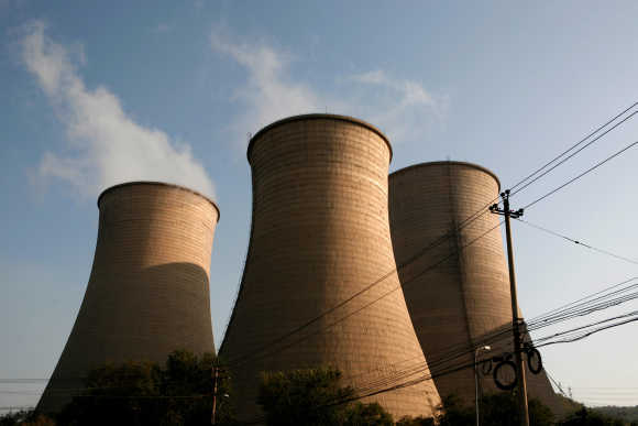 Cooling towers at a thermal power plant are pictured near Pingguoyuan in Beijing.