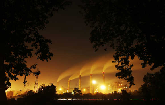 A thermal power station is seen through trees in Nagpur.