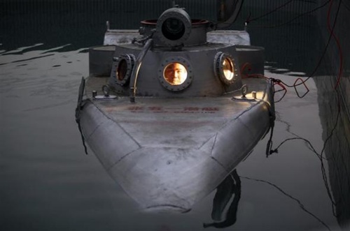 Zhang Wuyi sits in his double-seater submarine during a test operation at an artificial pool near a shipyard in Wuhan, Hubei province.
