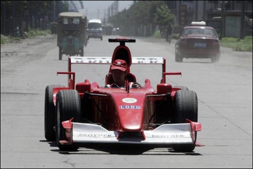 Zhao Xiuguo drives a homemade model of Formula One car in Tangshan, Hebei Province, some 180km (113 miles) east of Beijing.