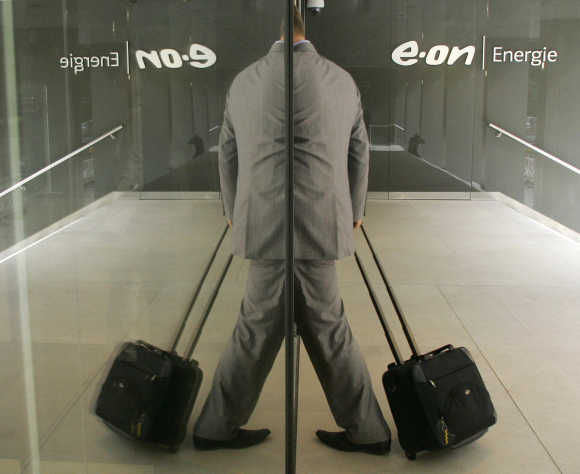 A reporter arrives for the annual news conference of the German E.ON Energie in Munich.