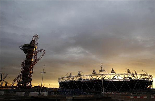 Sun sets behind the Olympic stadium and Anish Kapoor's ArcelorMittal Orbit tower in Stratford, east London.