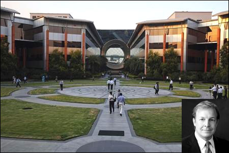 Employees walk in front of a building dubbed the ''washing machine'', a well-known landmark built by Infosys. Inset: Stephen Pratt.