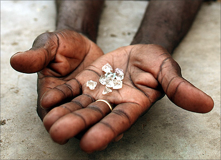 An illegal diamond dealer from Zimbabwe displays diamonds for sale in Manica, near the border with Zimbabwe
