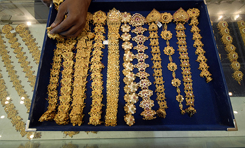 A salesman displays gold jewellery for the camera at a showroom in the southern Indian city of Hyderabad.