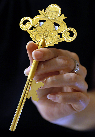 An employee holds a gold key during a photo opportunity at a jewellery shop in Seoul.