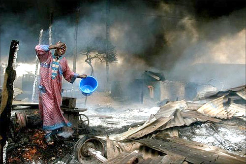 A man rinses soot from his face at the scene of a gas pipeline explosion near Nigeria's commercial capital Lagos.