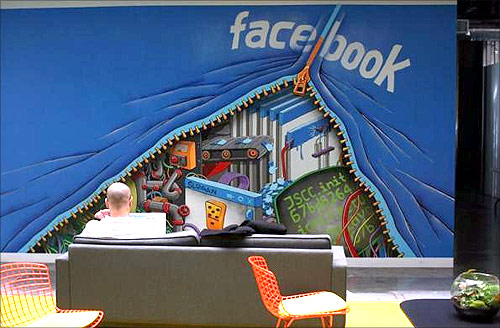 An employee works on a computer at the new headquarters of Facebook in Menlo Park.