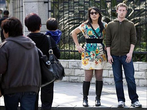 Facebook CEO Mark Zuckerberg and his girlfriend Priscilla Chan walk near Fuxing Road in Shanghai.