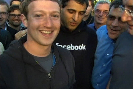 Facebook Chief Executive Mark Zuckerberg, shown in this image from Reuters video, reacts after remotely ringing the Nasdaq's opening bell at the social network's headquarters in Menlo Park, California.