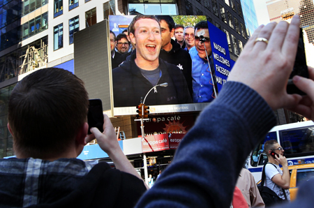 Facebook Inc. CEO Mark Zuckerberg is seen on a screen televised from their headquarters in Menlo Park moments after their IPO launch in New York.