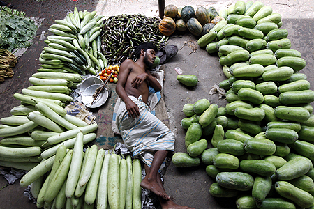 A vegetable vendor takes a nap during a hot summer afternoon at Karwanbazar in Dhaka.