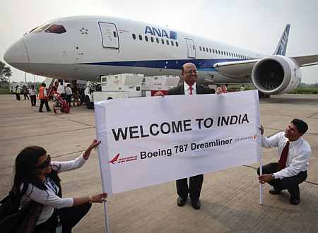 The president of Boeing India poses in front of the Boeing 787 Dreamliner.