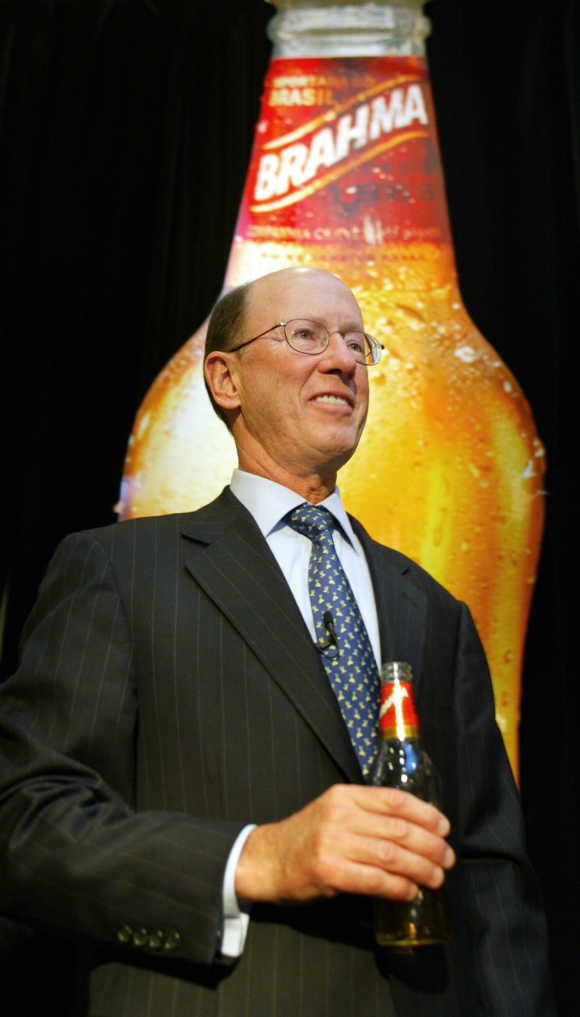 InBev CEO John Brock holds a bottle of Brahma beer in New York.