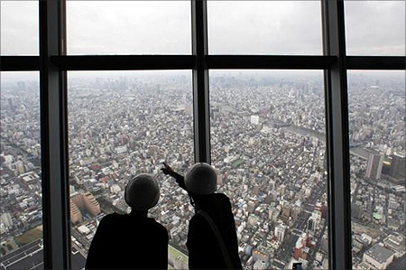 Reporters observe a panoramic view of the city of Tokyo from the first observatory deck