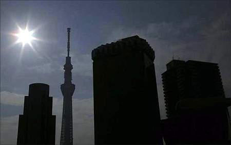 An eclipse is seen over Tokyo Sky Tree