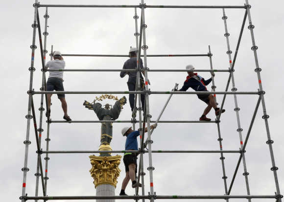 Workers assemble a stage in Independence Square in central Kiev, Ukraine.