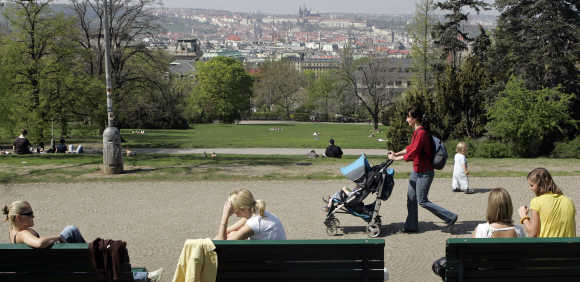 People enjoy a sunny day in Prague.