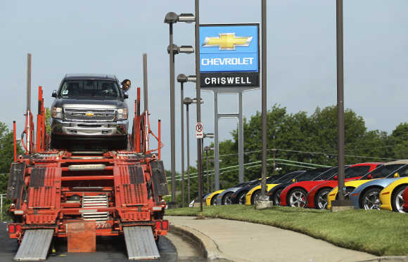 Driver Campbell unloads a Chevrolet Silverado pickup truck at Criswell Chevrolet in Maryland.