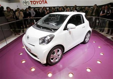 People watch the new Toyota iQ car.