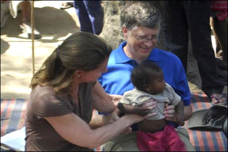 Bill Gates and his wife Melinda hold a child during their visit to a Danapur slum area near Patna on March 23, 2011.