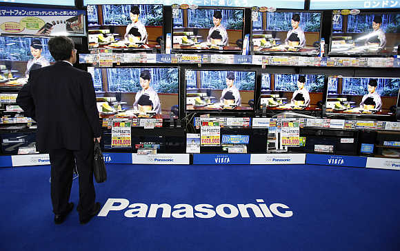 A man looks at Panasonic's Viera televisions displayed at an electronic store in Tokyo.