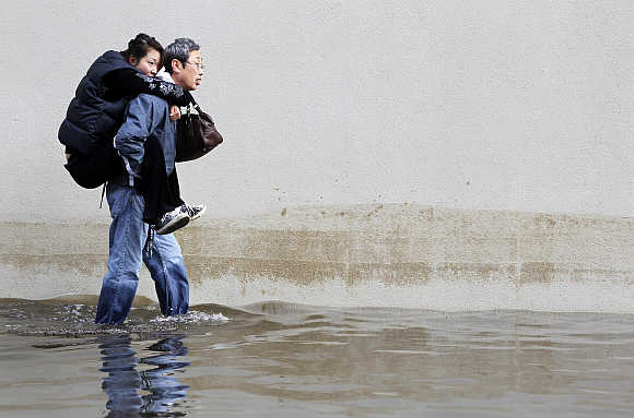 A man carries his wife through the floodwaters in Hoboken, New Jersey.
