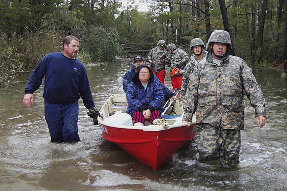 National Guard soldiers rescue people who were stranded in Mears, Virginia.