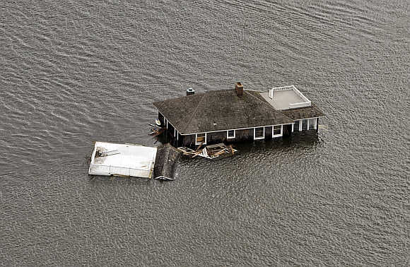 A house floats in the bay after it was washed from its foundation during Hurricane Sandy in Manotoloking, New Jersey.