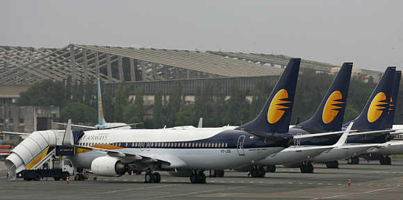 Jet Airways aircraft stand on the tarmac at the domestic airport terminal in Mumbai.