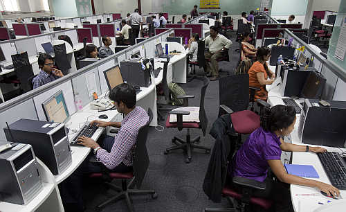 Workers are seen at their workstations on the floor of an outsourcing centre in Bangalore.
