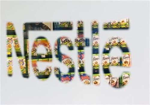 Nestle cereal boxes are pictured through a logo in the company supermarket at the Nestle headquarters in Vevey, Switzerland