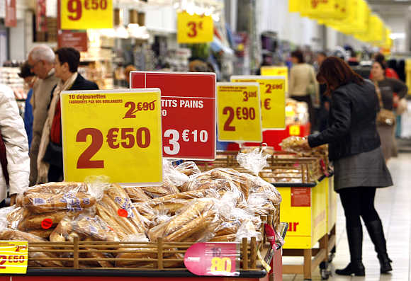 Discount signs are displayed in a Carrefour supermarket in Antibes, France.