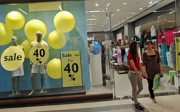 Shoppers leave a retail store inside a mall in Mumbai.