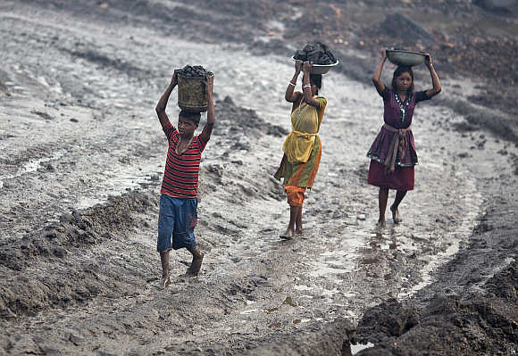 Labourers carry coal from an open cast coal field in Dhanbad, Jharkhand. Photo is for representation purpose only.