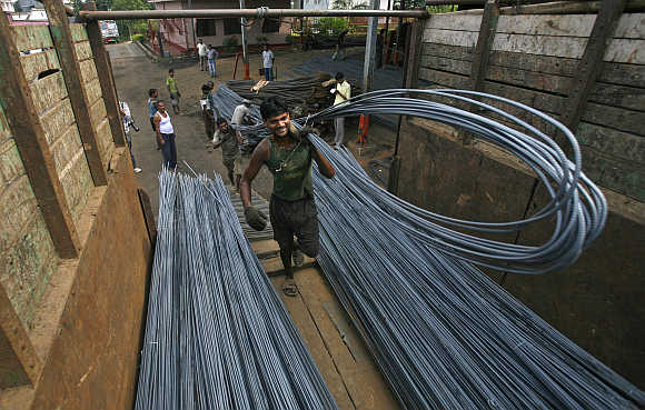 Labourers load iron rods onto a vehicle at a steel factory on the outskirts of Agartala. Photo is for representation purpose only.