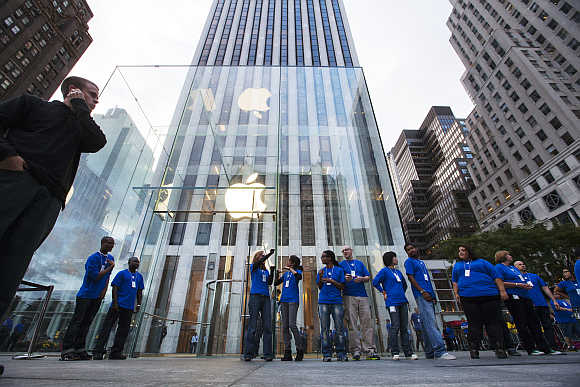 Employees line up outside the Apple Store on Fifth Avenue in New York.