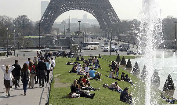 People relax at Trocadero square near the Eiffel tower in Paris.