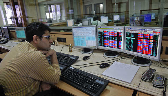A broker monitors share prices at a firm in Mumbai.