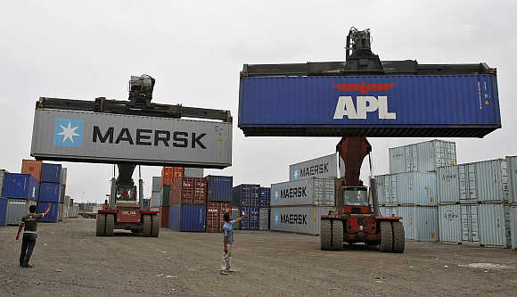 Mobile cranes prepare to stack containers at Thar Dry Port in Sanand, Gujarat.