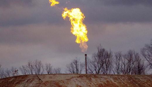 A gas flare burns at a fracking site