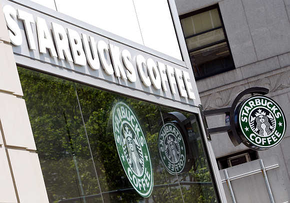 Starbucks signs are seen outside one of its stores in New York.