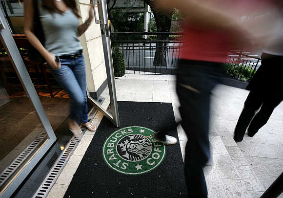 Starbucks customers walk out of store on Sao Paulo's Alameda Santos, Brazil.